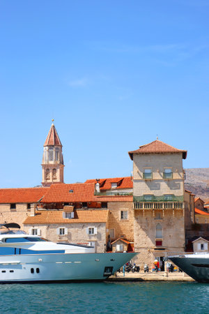 Beautiful old buildings, boats and yachts on the promenade in Trogir, Croatia. Sunny summer day in Trogir.の写真素材