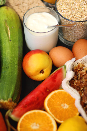 Various healthy fruits, vegetables and cereals on dark background. Selective focus.の写真素材