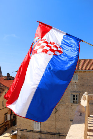 Croatian flag blowing in the wind on the bell tower of The Cathedral of St. Lawrence, landmark in Trogir, Croatia.の写真素材