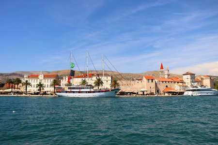 Beautiful old buildings, boats and yachts on the promenade in Trogir, Croatia. Sunny summer day in Trogir.の写真素材