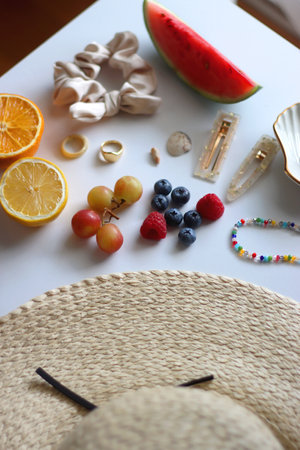 Straw hat, sunglasses, seasonal fruit, seashells and colorful accessories on white backgrounds. Cute...