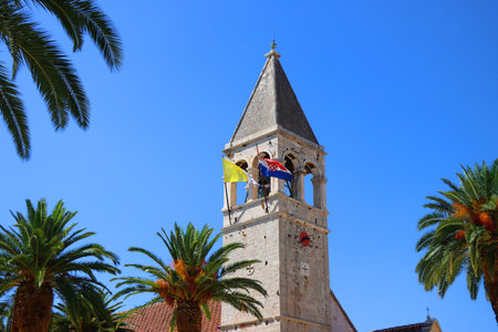 Historical church and monastery of Saint Dominic, in Trogir, Croatia. Flags of Croatia and Vatican City on the tower.の写真素材