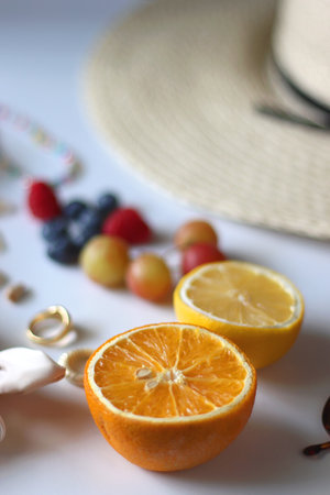 Straw hat, sunglasses, seasonal fruit, seashells and colorful accessories on white backgrounds. Cute...