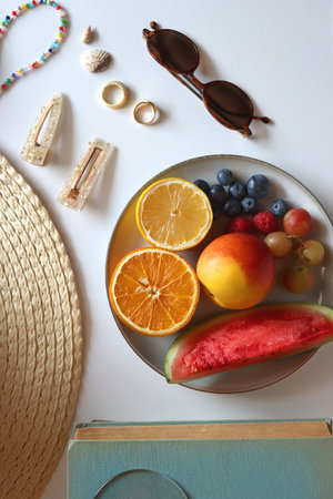 Fresh fruit, chocolate and accessories. Summer essentials on the table. Top view.の写真素材
