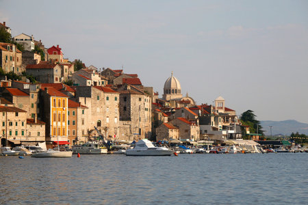 Historical buildings and boats on the coast of Sibenik, Croatia.の写真素材