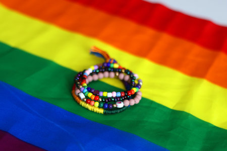 Rainbow friendship bracelets and pride flag. Pride month concept, selective focus.の写真素材