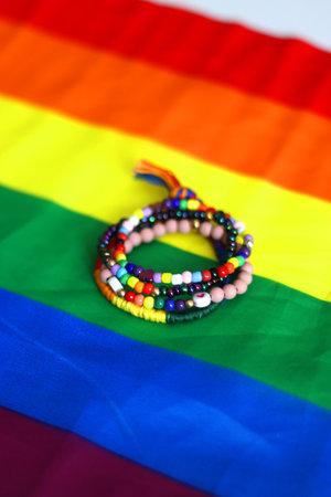 Rainbow friendship bracelets and pride flag. Pride month concept, selective focus.の写真素材