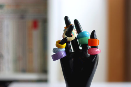 Hand figurine with colorful various rings. Selective focus.の写真素材