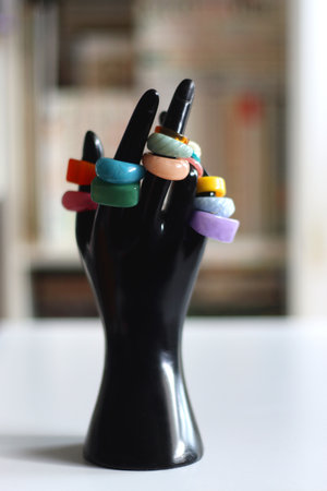 Hand figurine with colorful various rings. Selective focus.の写真素材