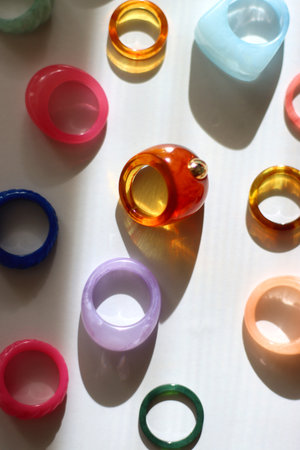 Collection of colorful plastic rings on white background. Top view.