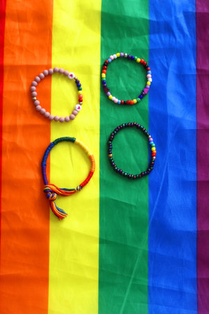 Rainbow friendship bracelets and pride flag. Pride month concept, top view.の写真素材