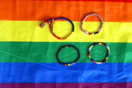 Rainbow friendship bracelets and pride flag. Pride month concept, top view.の写真素材