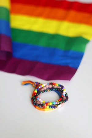 Rainbow friendship bracelets and pride flag. Pride month concept, selective focus.の写真素材