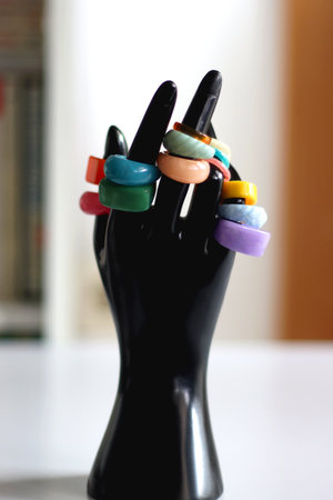 Hand figurine with colorful various rings. Selective focus.の写真素材