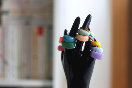 Hand figurine with colorful various rings. Selective focus.の写真素材