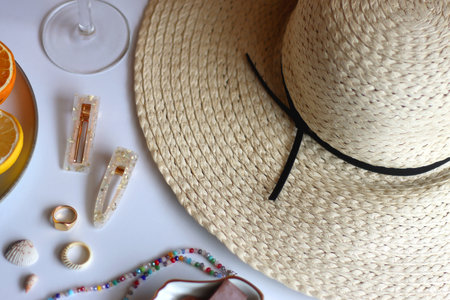 Glass of cocktail, straw hat, sunglasses, books, fresh fruit, chocolate and accessories. Summer...