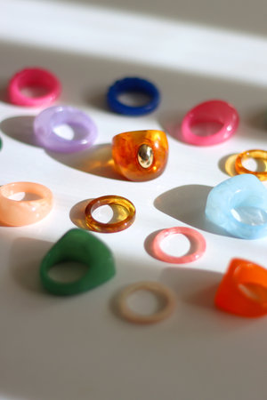 Collection of colorful plastic rings on white background. Selective focus.