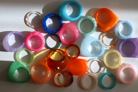 Collection of colorful plastic rings on white background. Top view.