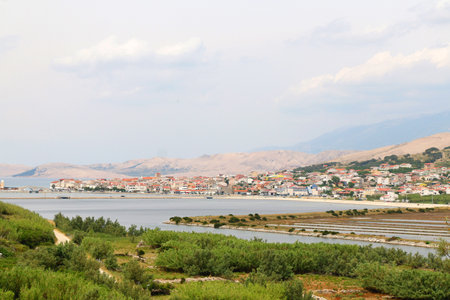 Traditional saltwork and skyline of town Pag, on island Pag, Croatia.