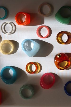 Collection of colorful plastic rings on white background. Top view.