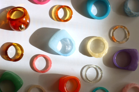 Collection of colorful plastic rings on white background. Top view.