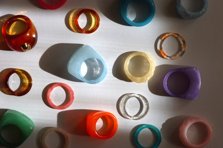 Collection of colorful plastic rings on white background. Top view.