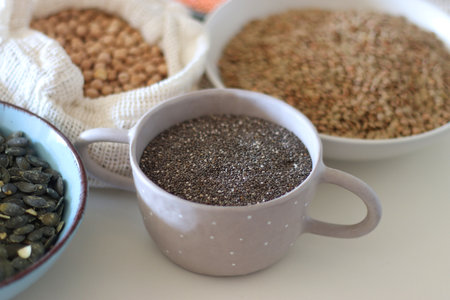 Bowls and bags full of various healthy grains and legumes. Selective focus.の写真素材