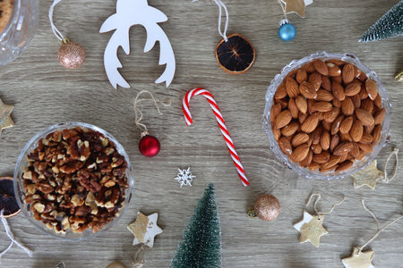 Various Christmas decorations, cookies, chocolate and nuts on wooden background. Flat lay.の写真素材