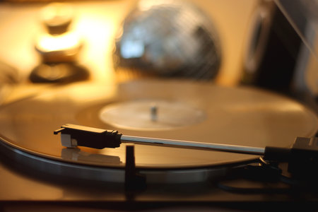Playing vinyl record on the gramophone at home. Selective focus.