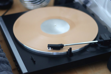 Playing vinyl record on the gramophone at home. Selective focus.の写真素材