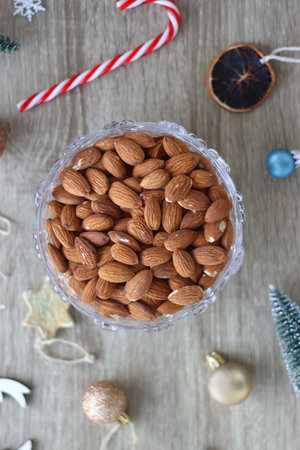 Various Christmas decorations, cookies, chocolate and nuts on wooden background. Flat lay.の写真素材