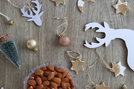 Various Christmas decorations, cookies, chocolate and nuts on wooden background. Flat lay.の写真素材