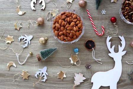 Various Christmas decorations, cookies, chocolate and nuts on wooden background. Flat lay.の写真素材