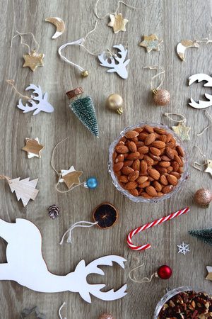 Various Christmas decorations, cookies, chocolate and nuts on wooden background. Flat lay.の写真素材