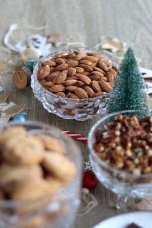 Various Christmas decorations, cookies, chocolate and nuts on wooden background. Selective focus.の写真素材