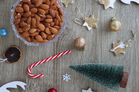 Various Christmas decorations, cookies, chocolate and nuts on wooden background. Flat lay.の写真素材