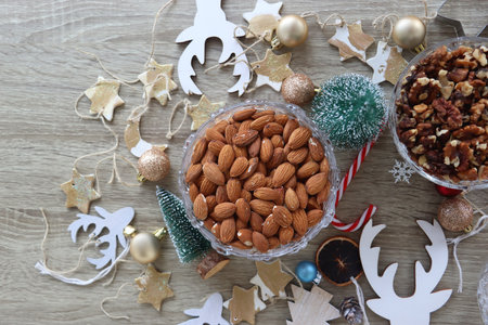 Various Christmas decorations, cookies, chocolate and nuts on wooden background. Flat lay.の写真素材