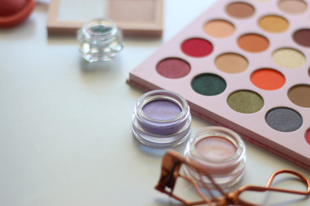 Various colorful cosmetic products on white background. Selective focus.