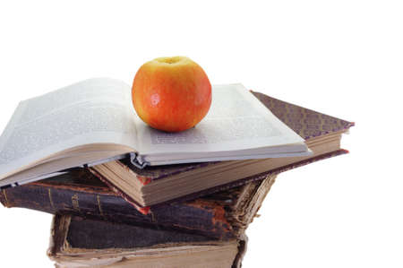 isolated apple on old books over white backgroundの写真素材