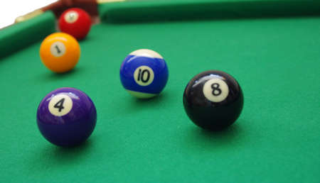 close-up of balls on green billiards table.