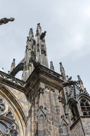The Cathedral of Saint Vitus (1344) in Prague, Czech Republic, side view architectural detail, with scary gargoyles protecting the towersの写真素材