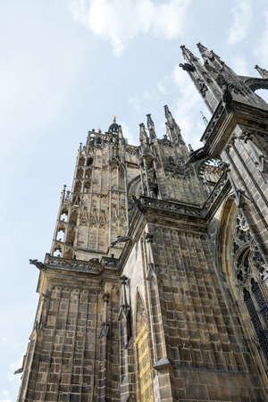 The Cathedral of Saint Vitus (1344) in Prague, Czech Republic, side view architectural detail, with scary gargoyles protecting the towersの写真素材