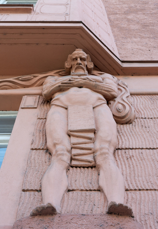 Architectural detail of a wise old man looking down on a building at the Old Town Square, Prague, Czech Republicの写真素材