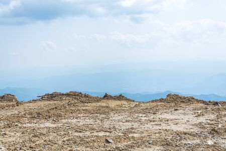 Sandy plateau of rocky mountain top against blue skyの写真素材