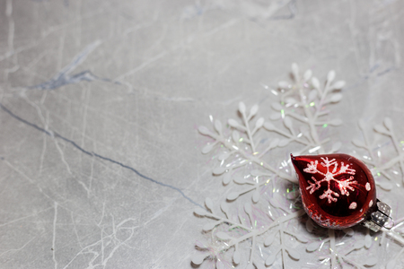 Red xmas ornament on bright holiday background with space for text. Merry christmas!の写真素材