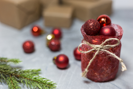 Red ornaments, branches and gifts on the blurred background, Christmas and New Year holiday conceptの写真素材
