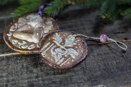 Handmade wooden ornaments with fir branches on the old floor. Concept of traditional Christmas celebration.の写真素材