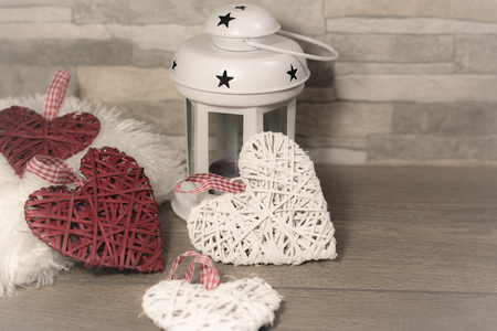 Winter composition with cozy pillow, lantern and heart ornaments. Winter holidays concept.の写真素材
