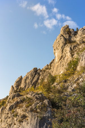 Top of the rocky hill and blue sky with cloudsの写真素材