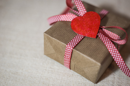 Gift box with red ribbon and hearts. Valentine's day greeting card with place for text.の写真素材